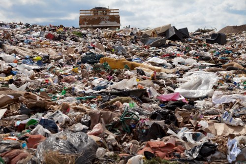 Builders sorting waste materials near a skip